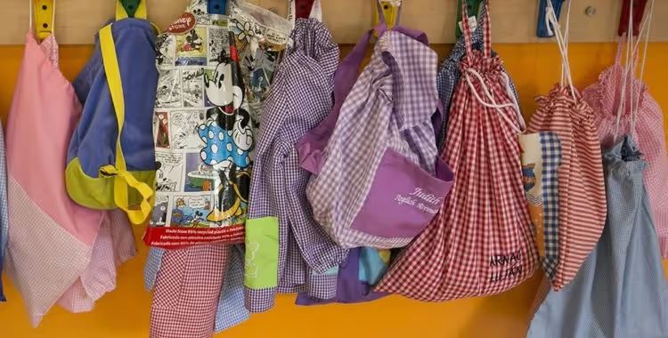 Children’s bags hanging on hooks at a daycare